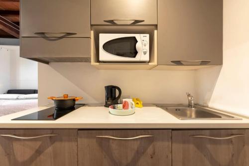 a kitchen with a sink and a microwave at Keys of Italy - Erta Canina 36 - Studio in S-Niccolò for 1 or 2 guests in Florence