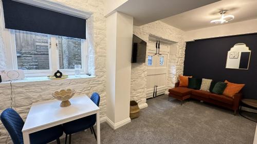 a living room with a couch and a table at The Pottery by Pureserviced in Plymouth