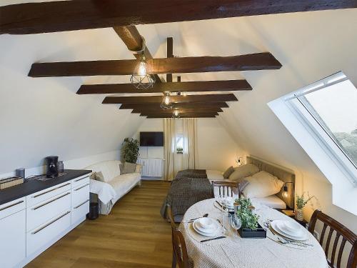 a kitchen and living room with a table and a couch at Apartment in Leverkusen Waldsiedlung in Leverkusen