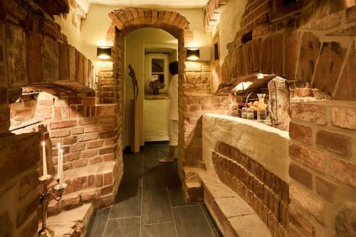 a hallway with a brick wall and an archway at Gut Pohnstorf in Alt Sührkow
