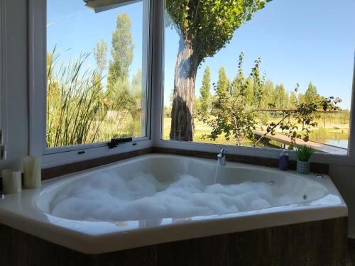 a bath tub in a room with a window at Finca La Escondida San Rafael in San Rafael