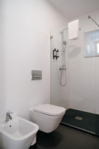 a bathroom with a toilet and a sink and a shower at Quinta do Louredo - Évora in Évora