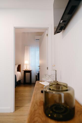 a room with a table with a glass bowl on it at Quinta do Louredo - Évora in Évora