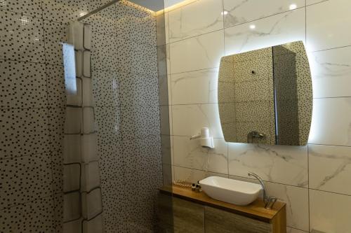 a bathroom with a sink and a mirror at Hotel City Star in Pristina