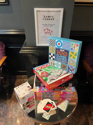 three boxes of games on a glass table at The California - London Kings Cross in London