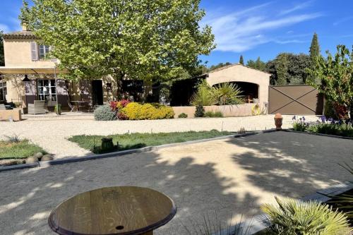 une maison avec une table au milieu d'une allée dans l'établissement Comfortable house with large garden and jacuzzi, à Rognes