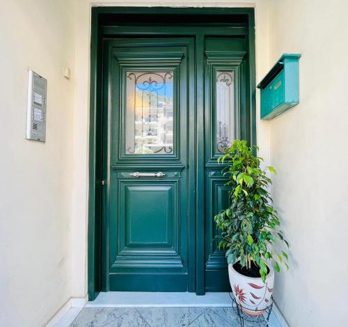 a green door with a potted plant in front of it at Dreamy Luxury Studio in Nafpaktos