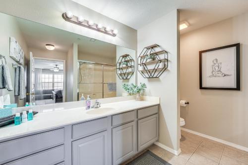 a bathroom with a sink and a mirror at Branson Condo with Pool about 3 Mi to Silver Dollar City in Branson West