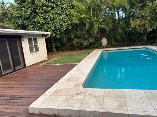 a swimming pool on a deck next to a house at Best Vacation rental house close to Kahala Beach ! in Honolulu