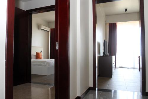 a mirror in a room with a bedroom at Flow Hotel Benguela in Benguela