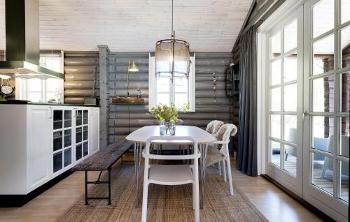 a kitchen with a white table and chairs at 3 Bedroom Amazing Home In Sæby in Sæby