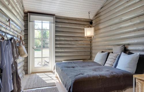 a bedroom with a large bed and a window at 3 Bedroom Amazing Home In Sæby in Sæby