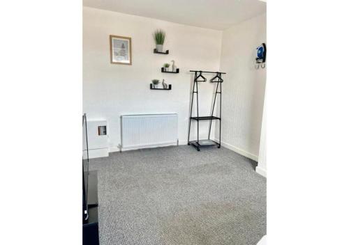 an empty room with a radiator and shelves on the wall at Pleasant 1 Bed Budget Apartment Near Blackpool City Centre 4 in Blackpool