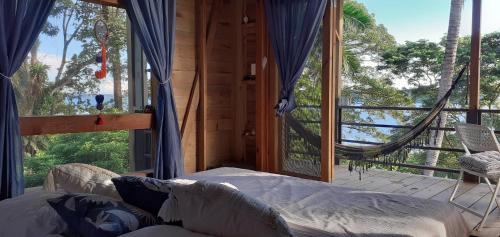 a bedroom with a bed and a large window at Colinas del Palmar in Bocas Town