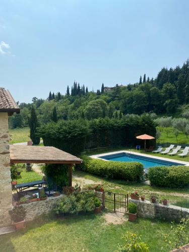 a backyard with a swimming pool and a gazebo at Agriturismo Val in Costermano