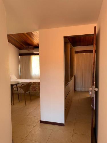 a door to a room with a kitchen and a table at Serrambi Resort in Porto De Galinhas