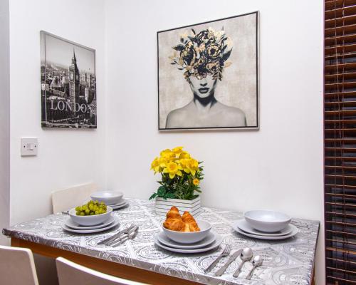 a dining room table with a plate of food on it at Luxury 3 King Bed Apartment Quayside in Manchester