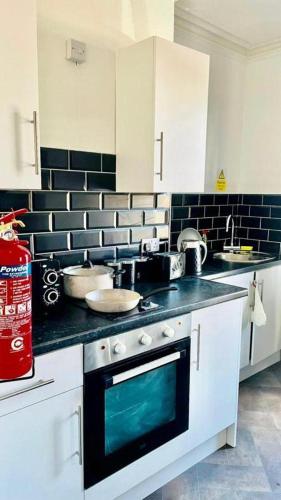 uma cozinha com um lavatório e um fogão forno superior em Comfy 1 Bed Budget Apartment Near Blackpool City Centre 3 em Blackpool