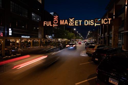 a busy city street at night with cars and lights at CoWorking Gym Pool Golfsim Steps from FultonMarket by Cloud9-160 in Chicago