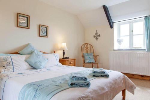 a bedroom with a bed with towels on it at Plas Drygarn Ty Gwyrdd Crymych in Crymmych Arms