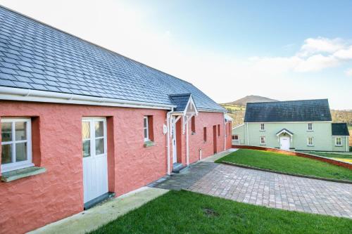 a red brick house with a driveway at Plas Drygarn Ty Gwyrdd Crymych in Crymych