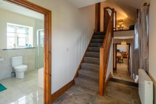 a staircase in a house with a bathroom at Plas Drygarn Ty Coch Crymych in Crymmych Arms