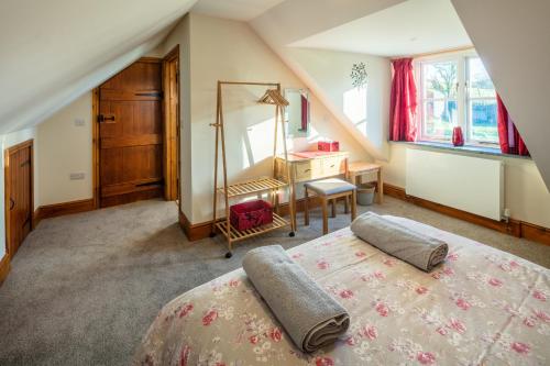 a bedroom with a bed and a desk and a mirror at Plas Drygarn Ty Coch Crymych in Crymmych Arms