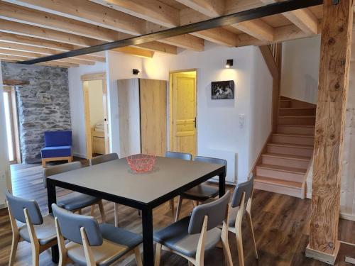 a dining room with a table and chairs at La MaiZon du Bois in Champagny-en-Vanoise