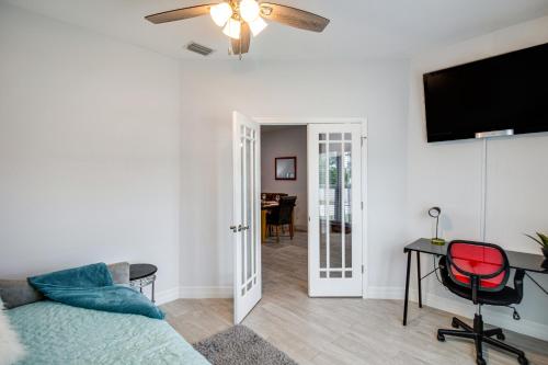 a living room with a couch and a flat screen tv at Lanai, Private Pool Lehigh Acres Home in Lehigh Acres