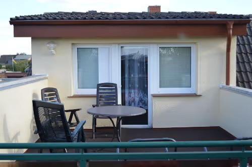 a patio with chairs and a table on a balcony at Ferienhaus Müritz - Brockmann in Warenshof