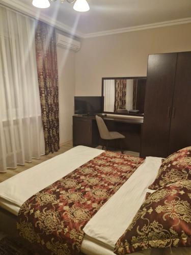 a hotel room with a bed and a desk at Nurtau in Pavlodar