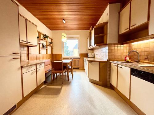 a kitchen with a table and a dining room at StayRoom Apartments I Haven im Zentrum von Linz in Linz