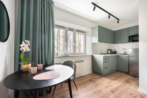 a kitchen and dining room with a table and chairs at Nowolipki Chic Studio in Warsaw
