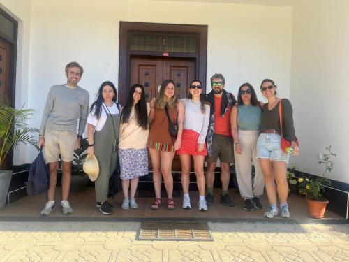 a group of people standing in front of a building at Queensland Hotel in Nuwara Eliya