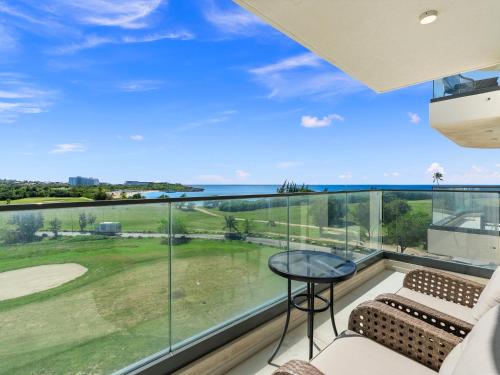 a room with a large window with a view of a golf course at Fourteen at Mullet Bay in Cupecoy