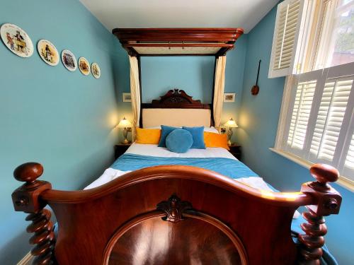 a bedroom with a wooden bed in a blue room at Trinity View YORK in York