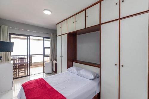 a bedroom with a bed and a large window at Vista Panoramica da Praia com 2qts, e vaga in Rio de Janeiro