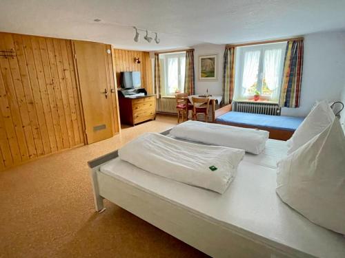 a hotel room with two beds and a table at Gasthaus Krone Holzschlag in Bonndorf im Schwarzwald