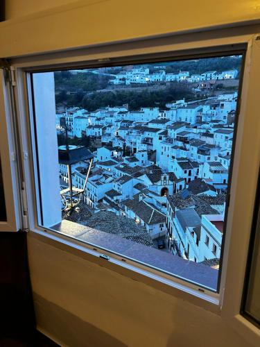 a view of a city from a window at Apartamento El Patio. in Setenil