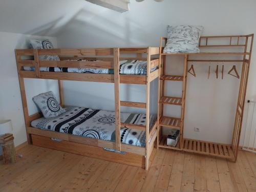 two bunk beds in a room with a bed at Gites Les Granges De Flolie in Beauteville