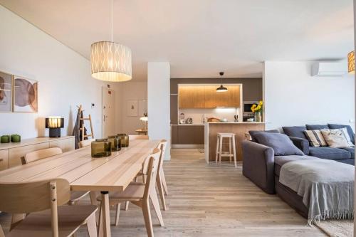 a living room and kitchen with a table and a couch at CENTRAL LOCATION - WITH POOL in Funchal