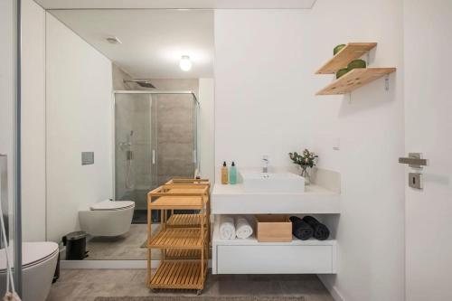 a bathroom with a sink and a toilet and a shower at CENTRAL LOCATION - WITH POOL in Funchal
