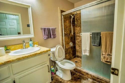 a bathroom with a sink and a toilet and a shower at Pet Friendly Rancher with Pool/SW Las Vegas in Las Vegas