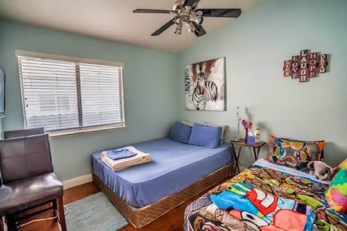 a bedroom with two beds and a ceiling fan at Pet Friendly Rancher with Pool/SW Las Vegas in Las Vegas