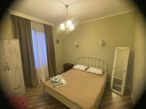 a small bedroom with a bed and a mirror at panorama in Mtskheta