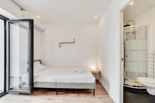 a bedroom with a bed and a sink and a mirror at Lapa Stylish Apartments in Lisbon