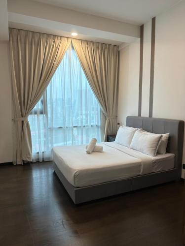 a bedroom with a bed with a large window at Crystal Suite at Opus Kuala Lumpur in Kuala Lumpur