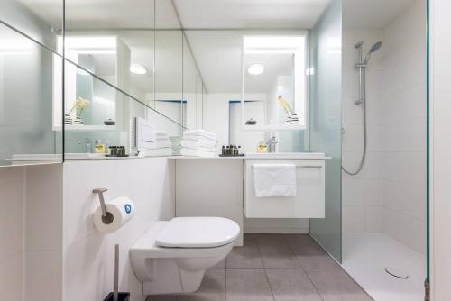 a white bathroom with a toilet and a shower at HM • Smart Studio with Terrace in Vienna