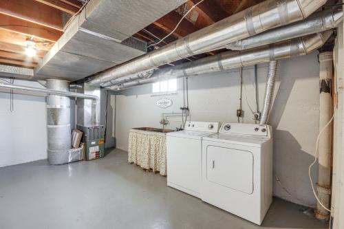 a laundry room with a washing machine and a counter at Downtown Billings Retreat Close to Shops and Eats! in Billings
