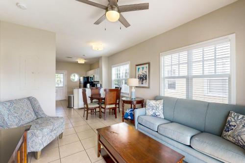 a living room with a blue couch and a table at Restful Retreat in Duck Key